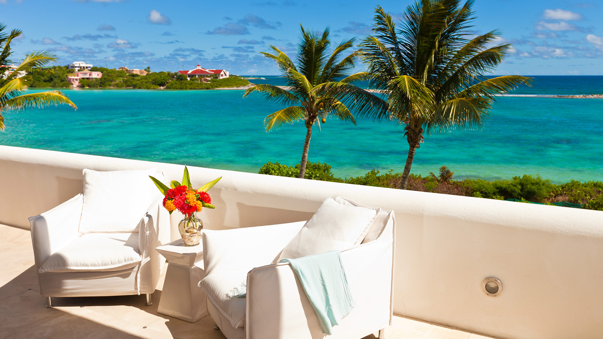 Gorgeous views and warm breezes abound on the pool deck of Le Bleu Villa — a luxury villa rental on Anguilla.
