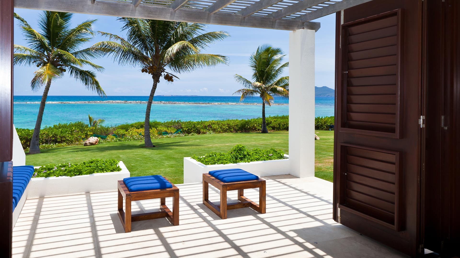 Master suites feature indoor/outdoor island living for ultimate relaxation during an Anguilla villa vacation at Le Bleu Villa.
